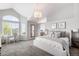 Spacious main bedroom with vaulted ceilings, sitting area, and view to the ensuite bath at 9574 Las Colinas Dr, Lone Tree, CO 80124