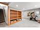 Open recreation room area features a built-in bookshelf and a bright window at 9574 Las Colinas Dr, Lone Tree, CO 80124