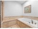 Inviting bathtub with tile surround, perfect for relaxation at 8555 W Quarles Pl, Littleton, CO 80128