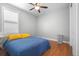 Bedroom featuring a ceiling fan, natural light from the window, and wood-look laminate flooring at 8555 W Quarles Pl, Littleton, CO 80128