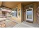 Inviting front porch featuring stone accents, a glass front door, and a cozy welcome mat at 8555 W Quarles Pl, Littleton, CO 80128