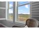 Close up on windows showcasing sprawling fields and distant mountains in this scenic property at 8555 W Quarles Pl, Littleton, CO 80128