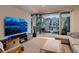 Bright living room with a large sliding glass door to a private balcony and sleek entertainment center at 3232 W 16Th Ave, Denver, CO 80204