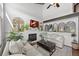 Comfortable living room with a fireplace, two sofas, a rustic coffee table, and several plants enhancing the cozy atmosphere at 9539 Bexley Dr, Highlands Ranch, CO 80126