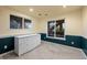 A bright basement space has neutral carpet, ample light, chair railing and white dresser at 10837 Fox Sedge Way, Highlands Ranch, CO 80126