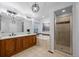 Bathroom offering a double sink vanity, soaking tub, enclosed shower and modern light fixtures at 10837 Fox Sedge Way, Highlands Ranch, CO 80126