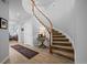 Elegant foyer with a curved staircase, hardwood floors, and natural light creating a grand entrance at 10837 Fox Sedge Way, Highlands Ranch, CO 80126