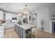 Spacious kitchen featuring a large center island, pendant lighting, and modern appliances at 10837 Fox Sedge Way, Highlands Ranch, CO 80126