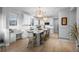 Modern kitchen with white cabinets, large central island with seating, and sleek countertops at 10837 Fox Sedge Way, Highlands Ranch, CO 80126