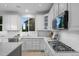 Well-lit kitchen with white cabinets, stainless steel appliances, and sleek countertops at 10837 Fox Sedge Way, Highlands Ranch, CO 80126