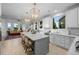 Bright, open kitchen with island seating, modern appliances, and seamless access to the living space at 10837 Fox Sedge Way, Highlands Ranch, CO 80126