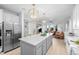 Bright, open kitchen featuring stainless steel appliances, a large island, and modern lighting at 10837 Fox Sedge Way, Highlands Ranch, CO 80126