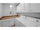Clean, well-lit laundry room with ample cabinet space and modern washer and dryer at 10837 Fox Sedge Way, Highlands Ranch, CO 80126