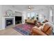 Cozy living room with a fireplace, comfortable seating, and large windows offering scenic views at 10837 Fox Sedge Way, Highlands Ranch, CO 80126