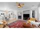 Open-concept living room with a fireplace, comfortable seating, and bright natural light at 10837 Fox Sedge Way, Highlands Ranch, CO 80126