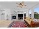 Comfortable living room with fireplace, ceiling fan, and natural light at 10837 Fox Sedge Way, Highlands Ranch, CO 80126