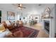 Open-concept space showcasing a living area and kitchen, with natural light, fireplace, and hardwood floors at 10837 Fox Sedge Way, Highlands Ranch, CO 80126
