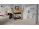 Spacious main bedroom showcasing a cozy fireplace, neutral carpet and adjoining bathroom entrance at 10837 Fox Sedge Way, Highlands Ranch, CO 80126