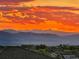 Spectacular mountain view from rooftop at sunset showing layered ranges and colorful sky above town at 10837 Fox Sedge Way, Highlands Ranch, CO 80126