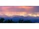 A panoramic mountain view at dusk sets a tranquil backdrop for this lovely home at 10837 Fox Sedge Way, Highlands Ranch, CO 80126