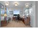 Bright home office with desk, built-in shelving, and natural light at 10837 Fox Sedge Way, Highlands Ranch, CO 80126
