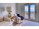 Comfortable sitting room with soft armchairs, accent table, and glass doors to a patio with mountain views at 10837 Fox Sedge Way, Highlands Ranch, CO 80126