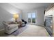 Sitting room with a cozy fireplace, plush chairs, and sliding glass door leading to a deck with a view at 10837 Fox Sedge Way, Highlands Ranch, CO 80126