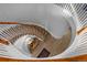 Unique spiral staircase with carpet and wood, lit from above at 10837 Fox Sedge Way, Highlands Ranch, CO 80126