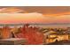 A captivating view captures the neighborhood, landscape and majestic mountains during a vibrant sunset at 10837 Fox Sedge Way, Highlands Ranch, CO 80126