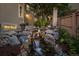 A soothing water feature enhances the curb appeal of the home and the landscaped front yard at 10837 Fox Sedge Way, Highlands Ranch, CO 80126