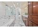 Bathroom boasting marble tile, soaking tub and glass enclosed shower at 1080 E 13Th Ave # 301, Denver, CO 80218