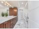 A modern bathroom with double sinks, marble floors and a soaking tub at 1080 E 13Th Ave # 301, Denver, CO 80218