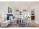 Sunlit bedroom with stylish decor, hardwood floors, and a glimpse into the ensuite bathroom at 1080 E 13Th Ave # 301, Denver, CO 80218
