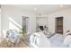 Comfortable bedroom featuring hardwood floors, a sitting chair, and views into the bathroom and closet at 1080 E 13Th Ave # 301, Denver, CO 80218