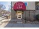 Street view of building entrance with stylish awning and well-maintained landscaping at 1080 E 13Th Ave # 301, Denver, CO 80218