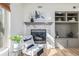 Close-up of a modern fireplace with stylish mantel, built-in shelving, and a comfortable chair at 1080 E 13Th Ave # 301, Denver, CO 80218