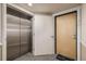 Hallway view of elevator and unit door, with a clean and modern design for easy access at 1080 E 13Th Ave # 301, Denver, CO 80218