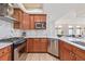 Stylish kitchen with stainless steel appliances, modern cabinets, and stone backsplash at 1080 E 13Th Ave # 301, Denver, CO 80218