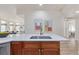 A modern kitchen island with a stainless steel sink and shaker-style cabinets at 1080 E 13Th Ave # 301, Denver, CO 80218