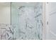 Shower featuring marble tile, glass doors, and rainfall shower head at 1080 E 13Th Ave # 301, Denver, CO 80218