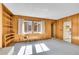 Cozy living room with built-in bookcase, wood paneling, and natural light at 3883 S Elm St, Denver, CO 80237