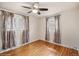 Bright bedroom with hardwood floors, ceiling fan, and windows providing ample natural light and fresh air at 7079 S Tamarac Ct, Centennial, CO 80112