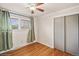 Bedroom features a ceiling fan, wood floors, window with blinds, and closet for comfortable living at 7079 S Tamarac Ct, Centennial, CO 80112