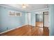 Bedroom with hardwood floors, large window, and closet providing ample storage and natural light for comfortable living at 7079 S Tamarac Ct, Centennial, CO 80112