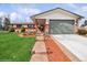 Well-maintained home with brick accents, attractive landscaping and a driveway with accent lighting at 7079 S Tamarac Ct, Centennial, CO 80112