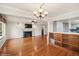 Open-concept living area with hardwood floors, fireplace, and seamless flow into the kitchen at 7079 S Tamarac Ct, Centennial, CO 80112