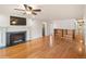 Spacious living room with a cozy fireplace, hardwood floors, and stylish built-in shelving at 7079 S Tamarac Ct, Centennial, CO 80112