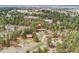 Aerial view of the home and barn in a densely wooded setting at 1730 Ward Cir, Franktown, CO 80116