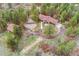 Aerial view of property with the main house and barn in a wooded setting at 1730 Ward Cir, Franktown, CO 80116
