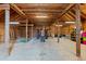 Exposed beam barn interior featuring a vintage tractor, string lights, and ample storage space at 1730 Ward Cir, Franktown, CO 80116
